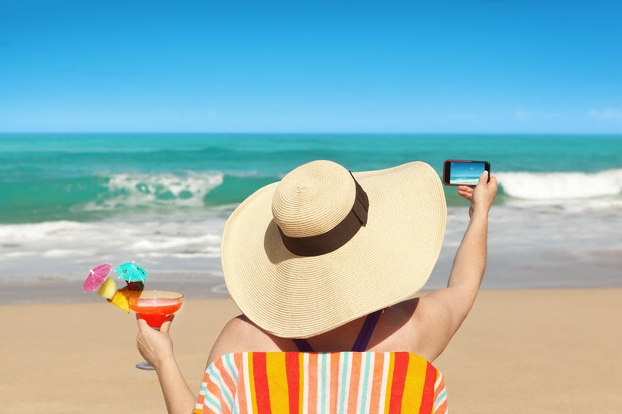 Woman Tourist Taking Beach Photo with Smartphone on Summer Vacation Photograph by YinYang