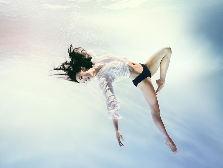 Woman underwater in zero gravity environment Photograph by Adam Pretty