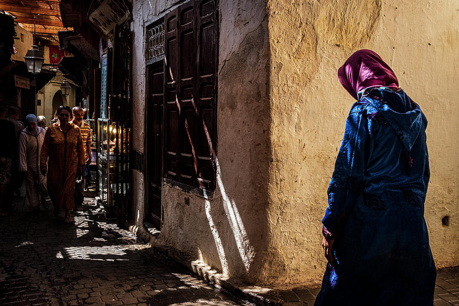 Woman walking in an alley of Fes Photograph by Ruben Vicente