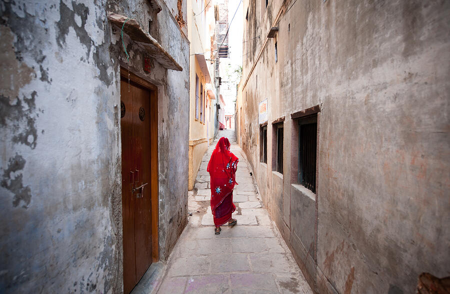 Woman walking on alley Photograph by Navid Baraty / Getty Images