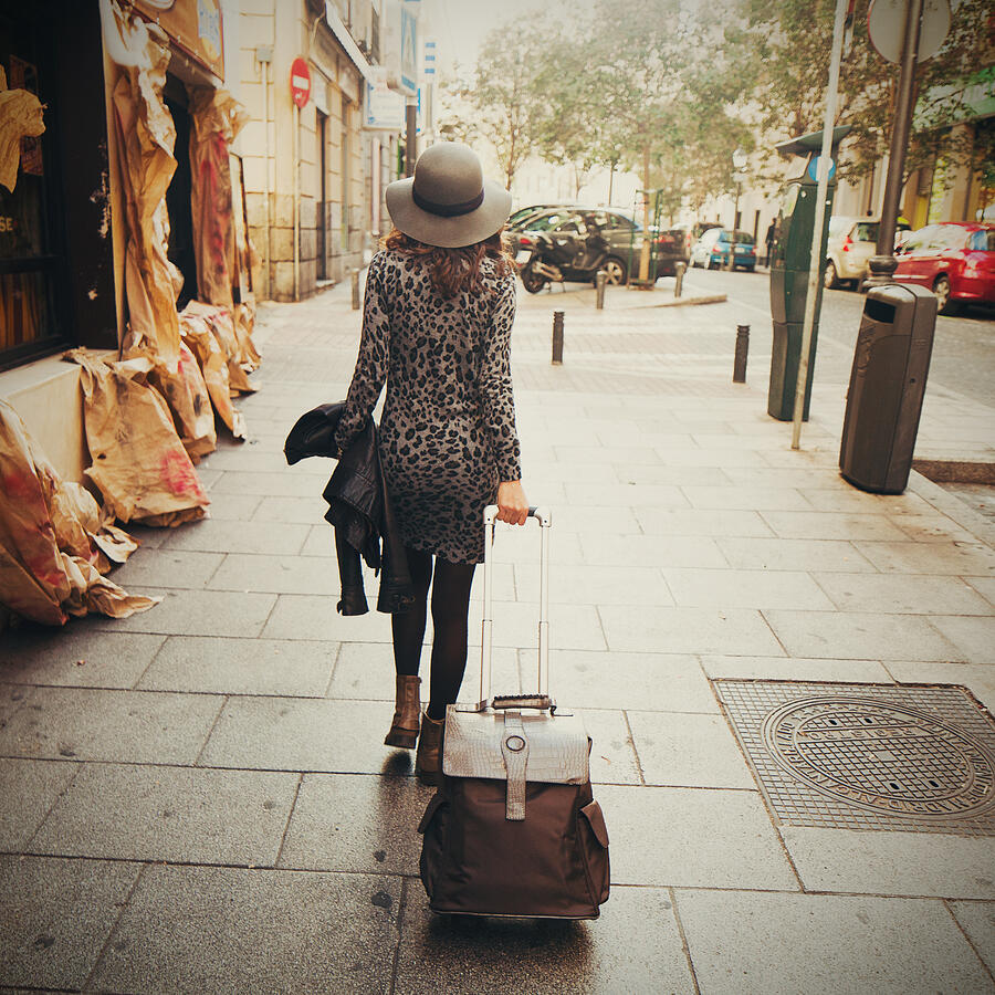 Woman walking with luggage Photograph by Rafael Elias