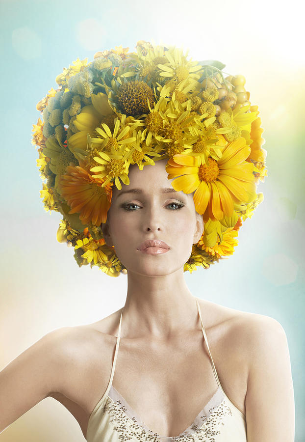 Woman wearing a fancy yellow hat made of flowers Photograph by Paper Boat Creative