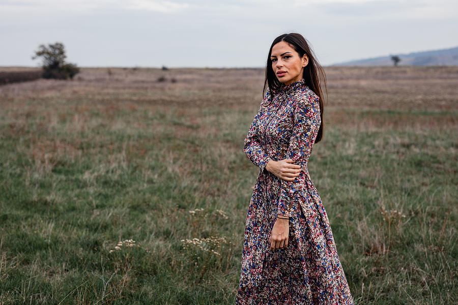 Woman wearing a floral pattern dress on an autumn day in nature Photograph by Domoyega