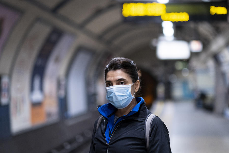 Woman wearing a mask on the London subway or tube Photograph by Alex Robinson Photography