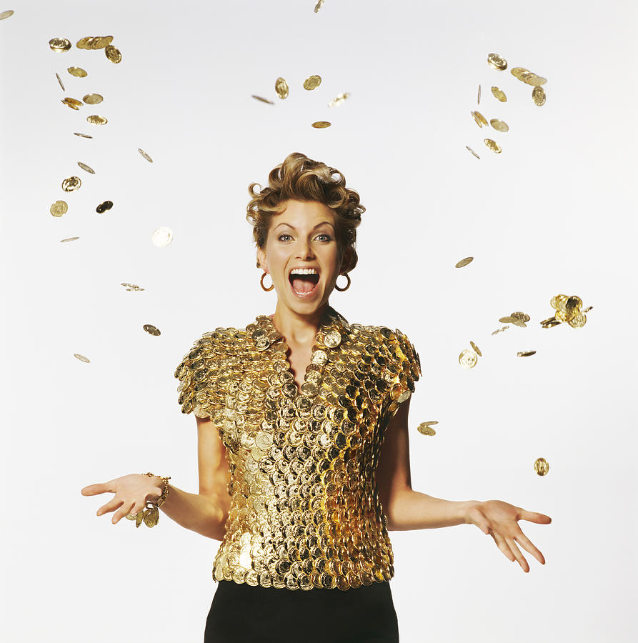 Woman Wearing a Top Made of Golden Coins, Coins Falling on Her Photograph by Digital Vision.