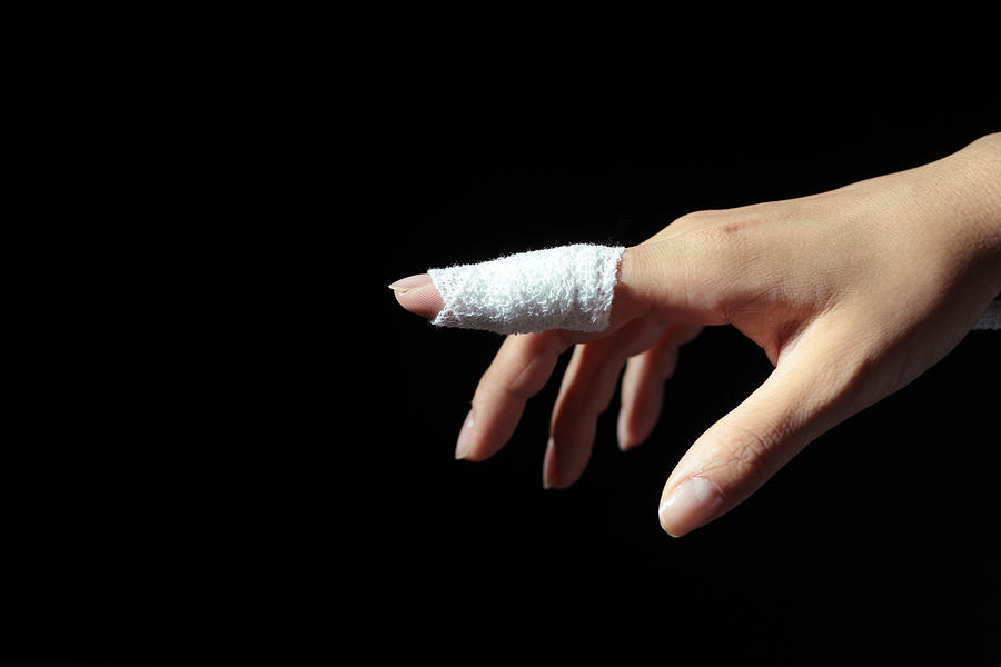 Woman Wearing Bandage On Pointing Finger,close-up Photograph by RunPhoto