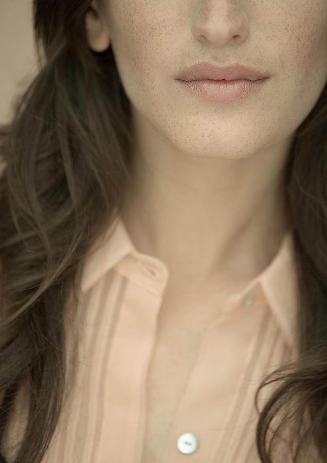 Woman wearing blouse, close-up of lower face and chest Photograph by PhotoAlto/ Matthieu Spohn