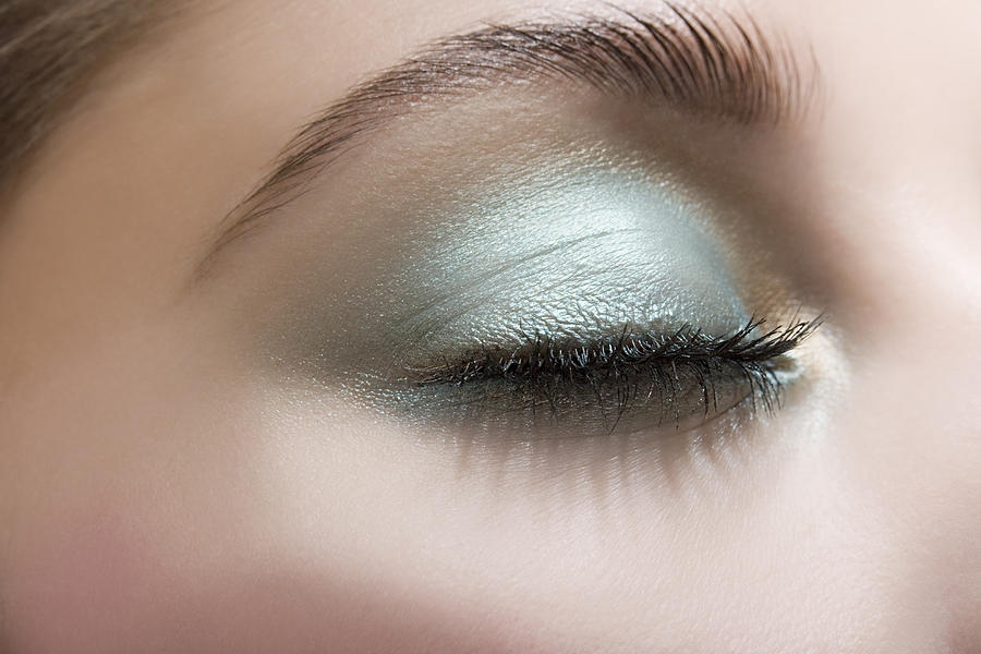 Woman wearing blue eye shadow Photograph by Image Source