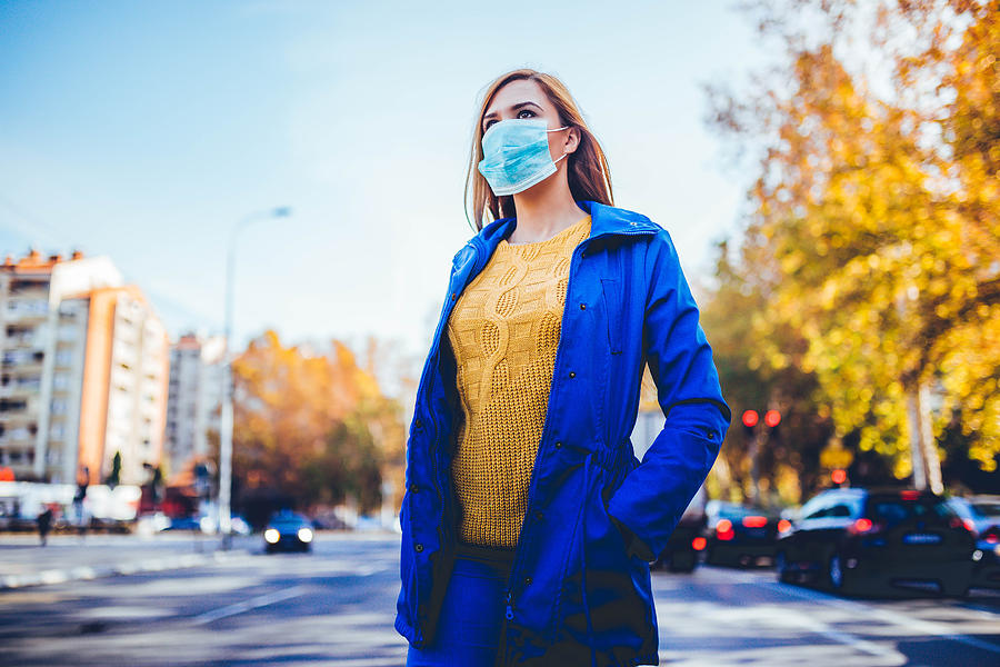 Woman wearing face mask because of pollution Photograph by LordHenriVoton