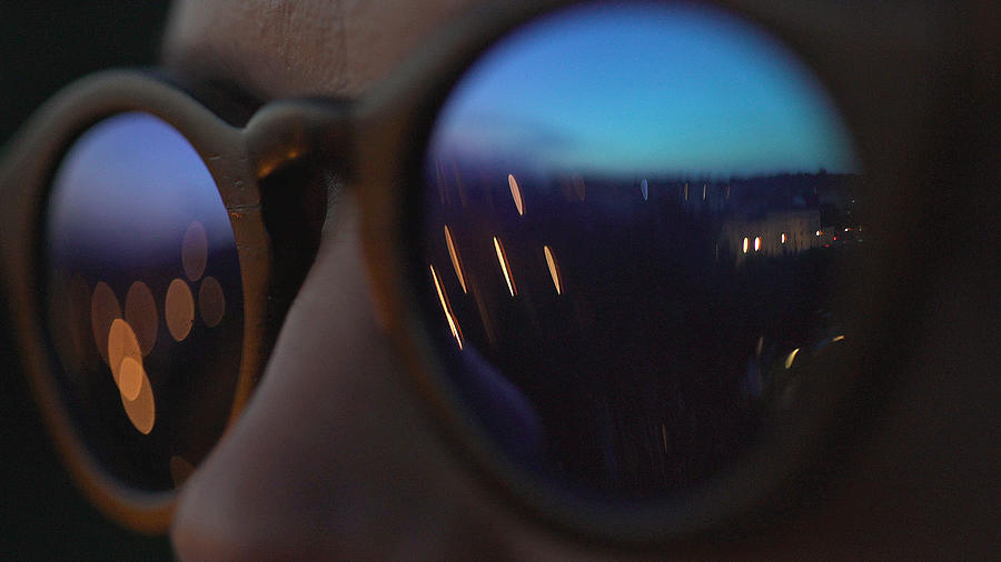 Woman wearing fashionable eyewear. City lights reflecting in glasses Photograph by Slavemotion