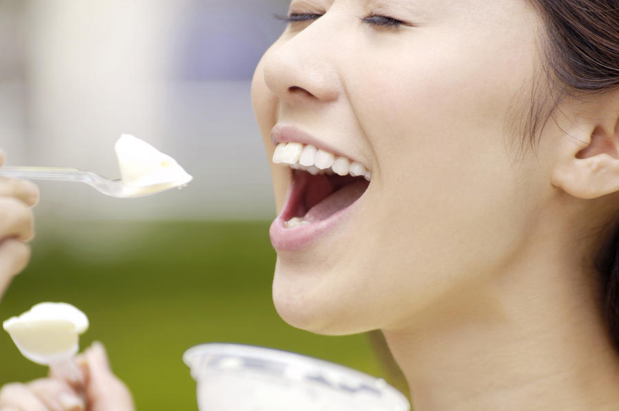 Woman who eats ice Photograph by Fotosearch