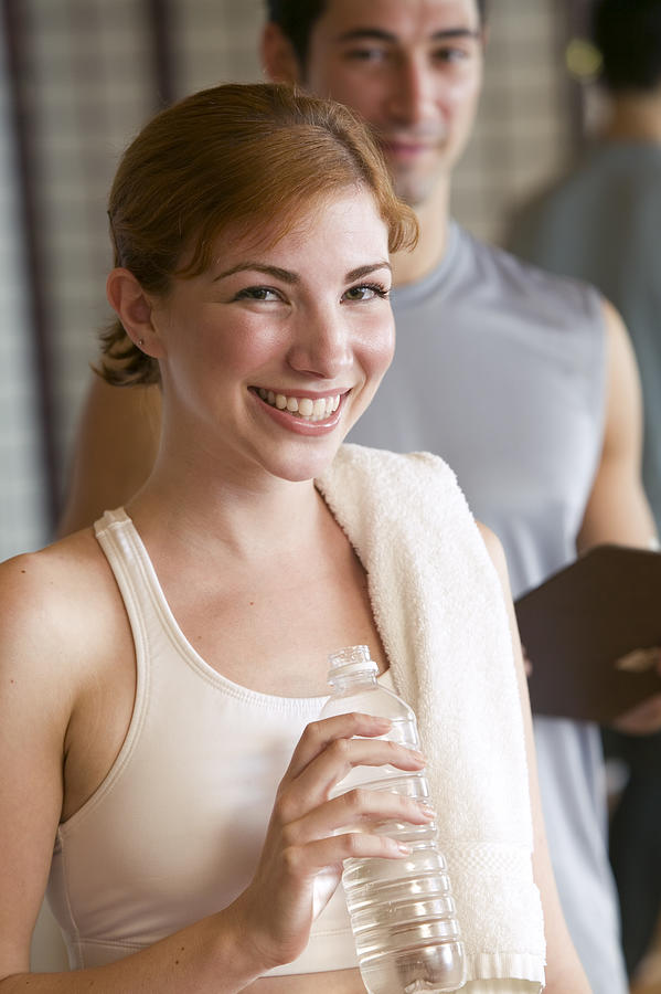 Woman with bottled water at gym Photograph by Comstock Images