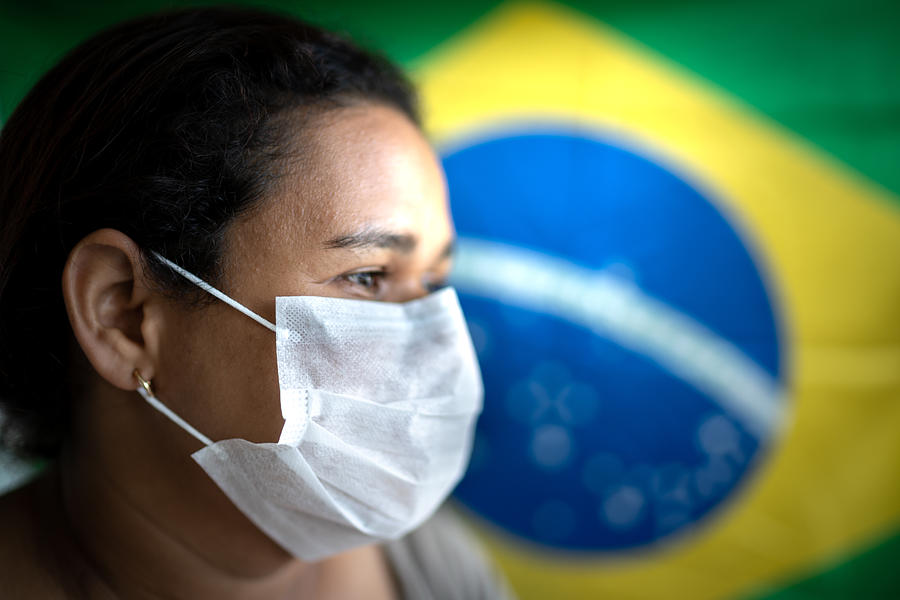 Woman with face mask and Brazilian flag on background Photograph by FG Trade