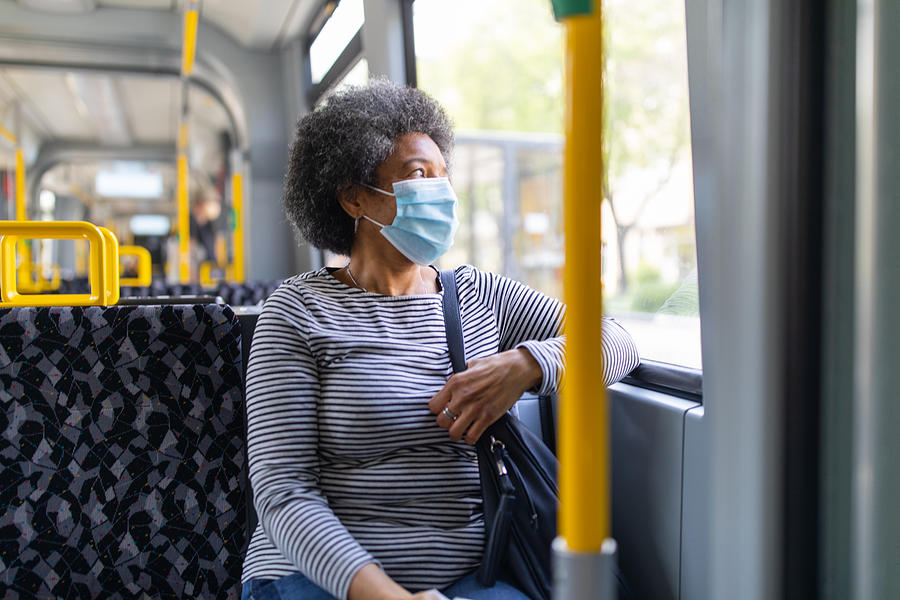 Woman with face mask travelling in the tram during Covid-19 outbreak Photograph by Alvarez