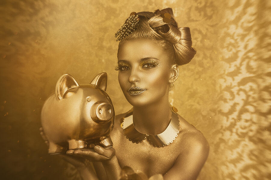 Woman With Golden Body Painting Holding A Golden Piggy Bank Photograph by Peter Zelei Images