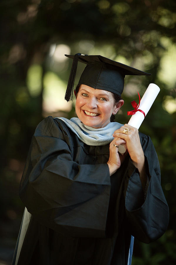 Woman with graduation diploma Photograph by Comstock Images