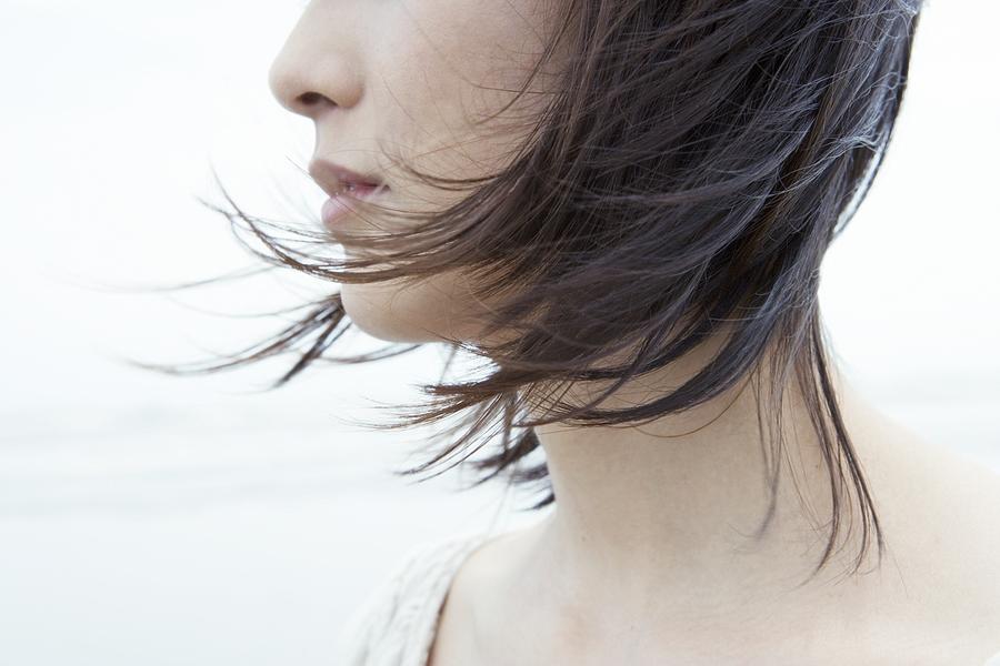 Woman with hair blowing in wind Photograph by Image Source