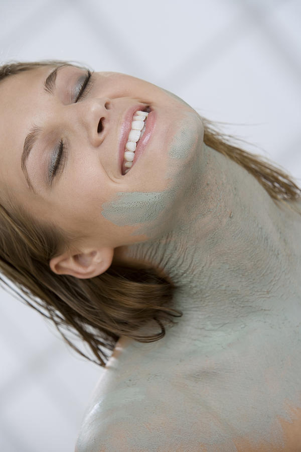 Woman with her eyes closed covered in mud treatment Photograph by Comstock Images