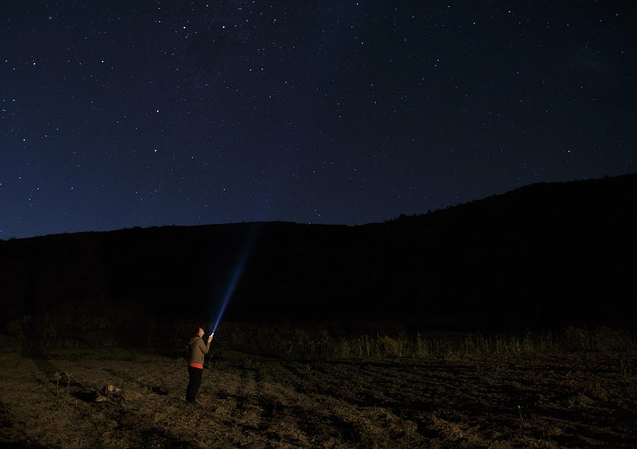 Woman with her torch under the Milky Way in the Andes Photograph by Ute Grabowsky