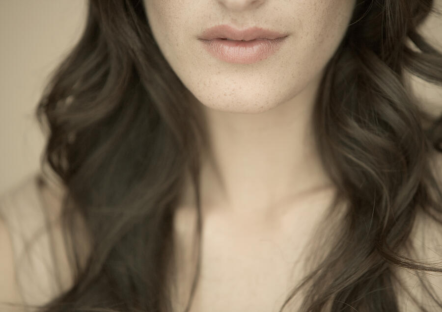 Woman with long hair, close-up of lower face and neck Photograph by PhotoAlto/ Matthieu Spohn
