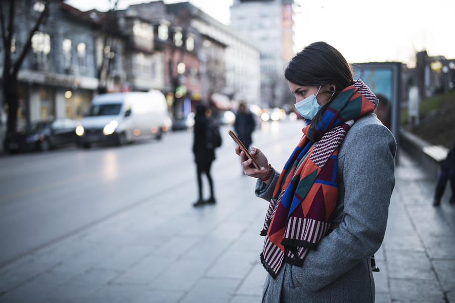 Woman With Mask Using Phone On The Street. Photograph by ArtistGNDphotography