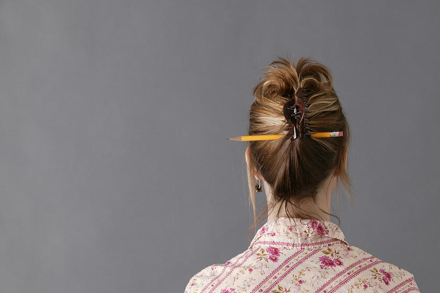Woman with pencil in hair Photograph by Comstock Images