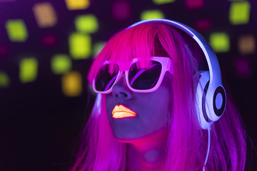 Woman with pink colored hair and sunglasses listening music Photograph by Vladimir Vladimirov