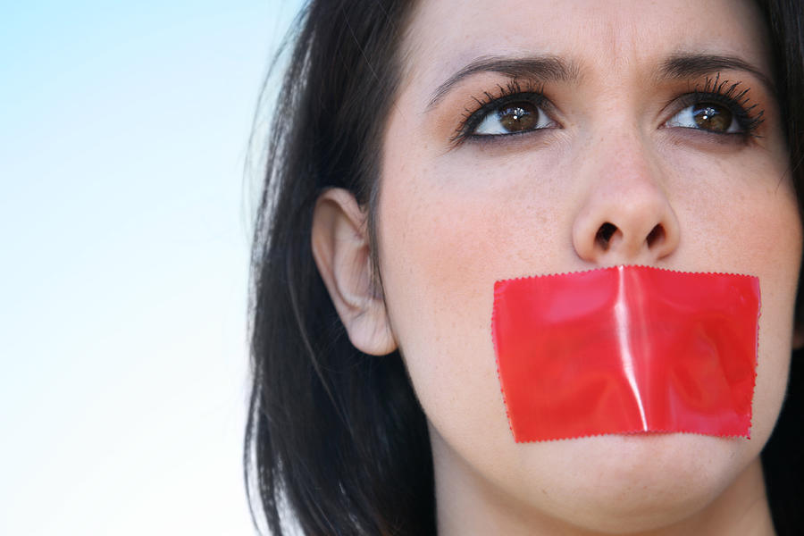 Woman With Red Tape Over Her Mouth Unable To Speak Photograph by SDI Productions