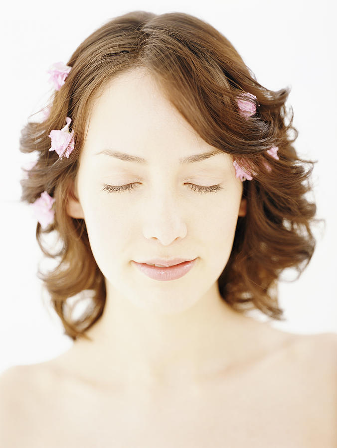 Woman With Rose Petals in Her Hair Photograph by Digital Vision.
