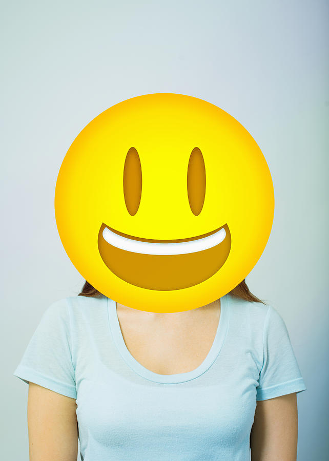 Woman with smiling emoji head Photograph by PM Images