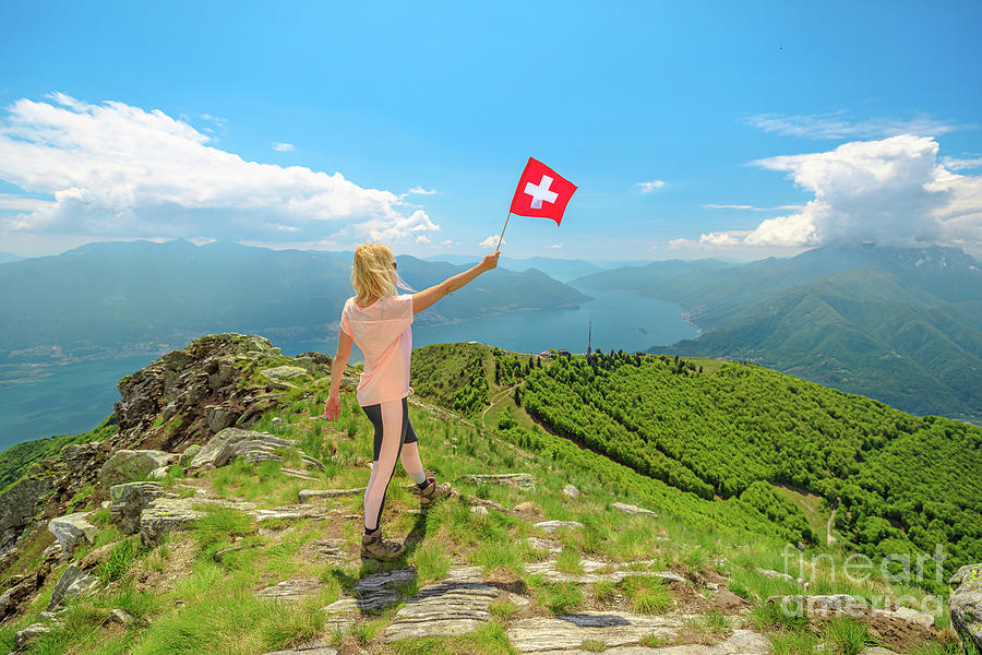 Woman with Swiss flag on Cardada mount Photograph by Benny Marty