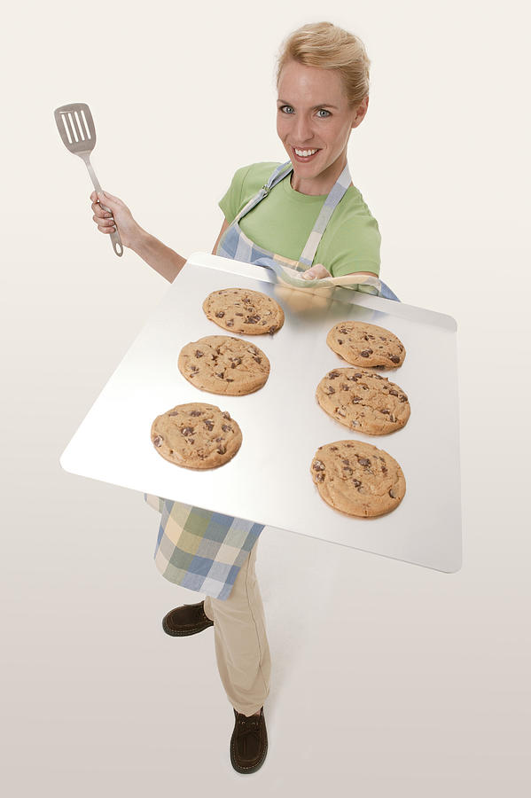 Woman with tray of cookies Photograph by Comstock Images