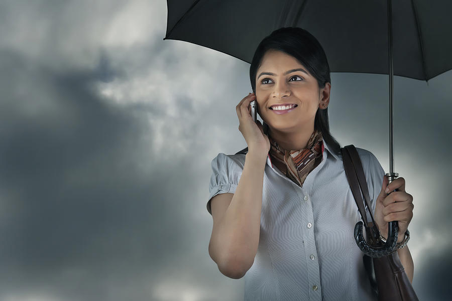 Woman with umbrella talking on mobile phone Photograph by Abhinandita Mathur 