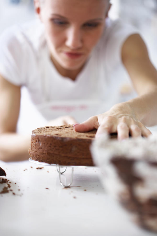 Woman working on cake Photograph by Marina Dyakonova