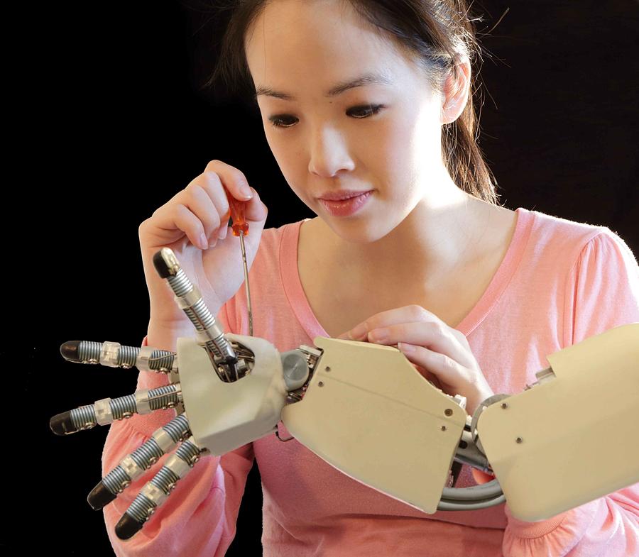 Woman Working On Robot Hand Photograph by Peter Cade