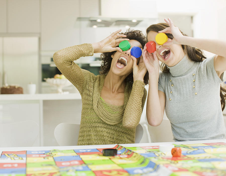 Women having fun with board game Photograph by Paul Bradbury