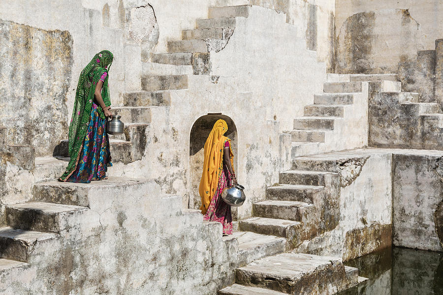 Women in saris carrying water at step well, Jaipur, Rajasthan, India Photograph by Jeremy Woodhouse