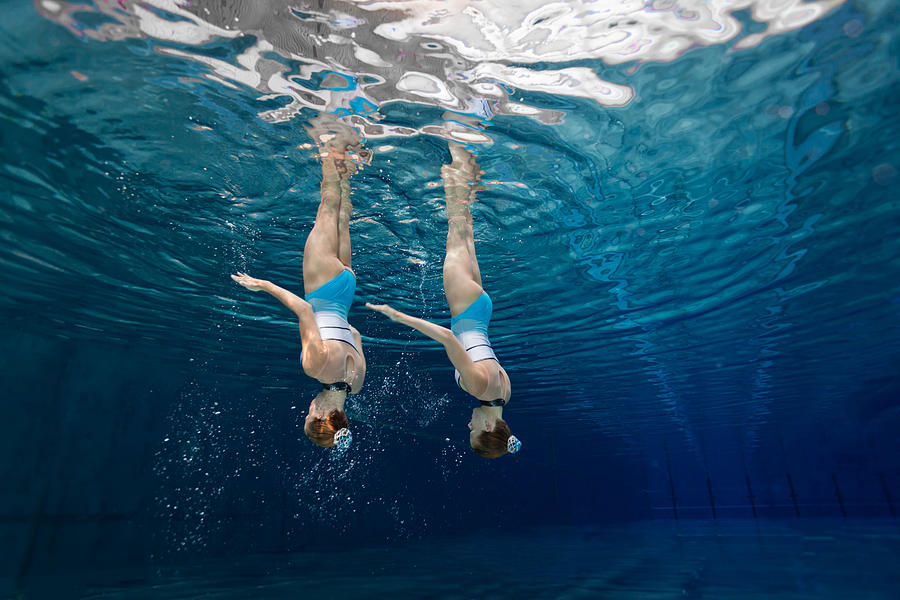 Women in Sport, teenage girls underwater synchronized swimming Photograph by Amriphoto