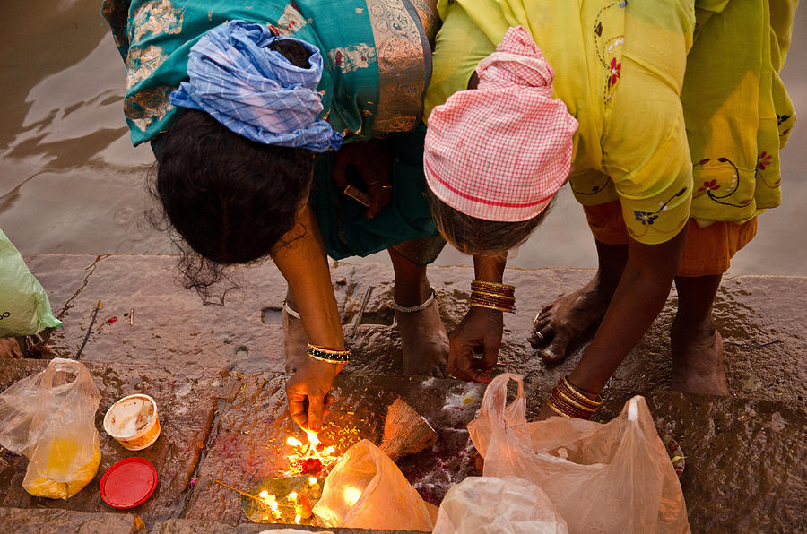Women lighting candles on the Ganges Photograph by Claire James Steinberg
