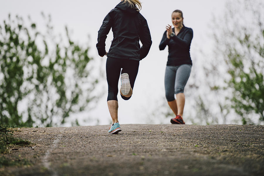 Women running together Photograph by Guido Mieth