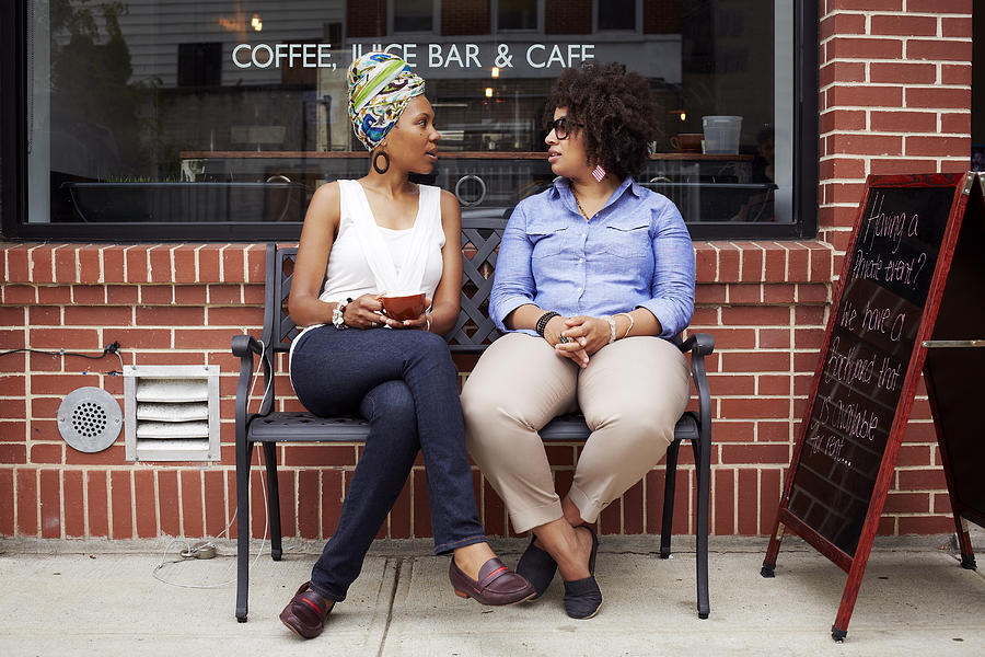Women talking outside coffee shop on city street Photograph by Granger Wootz