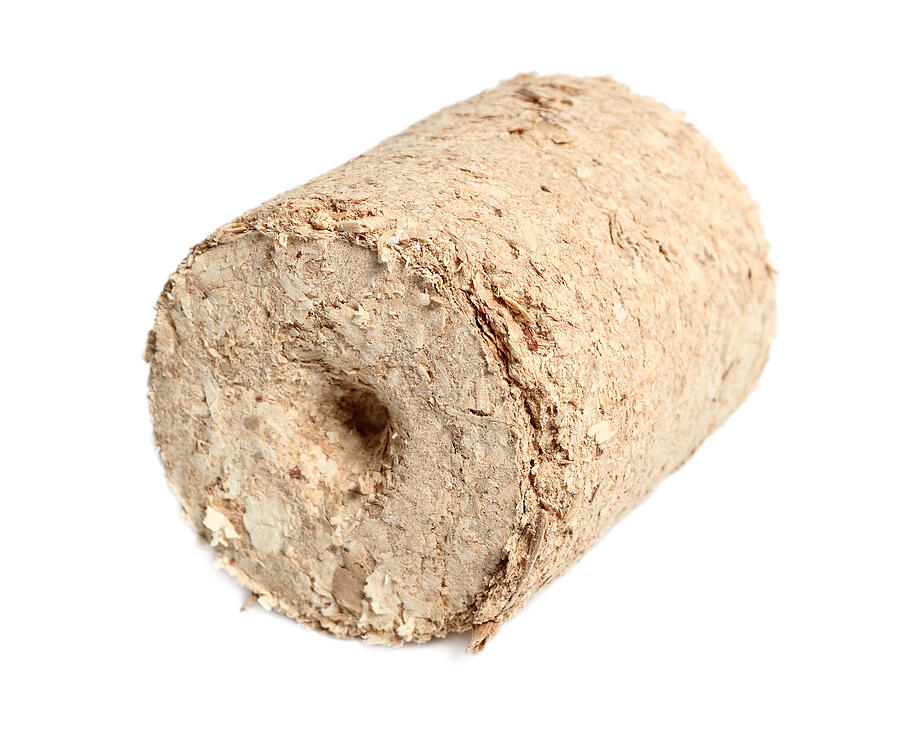 Wood briquette. Isolated on a white background. Photograph by Sanapadh