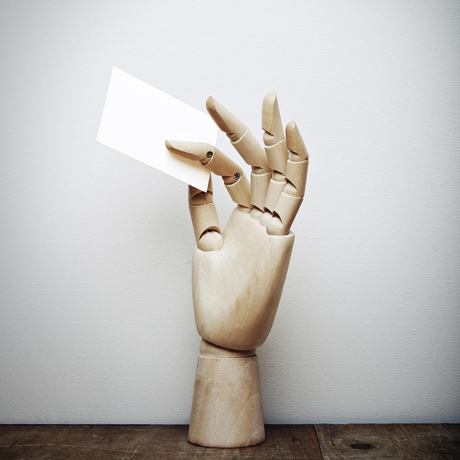 Wood hand holding blank business card Photograph by Sfio Cracho