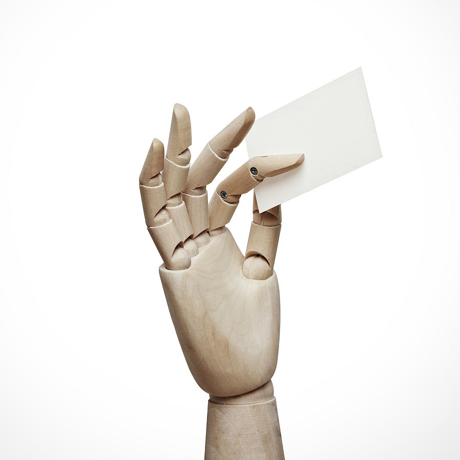 Wood hand with blank business card Photograph by Sfio Cracho