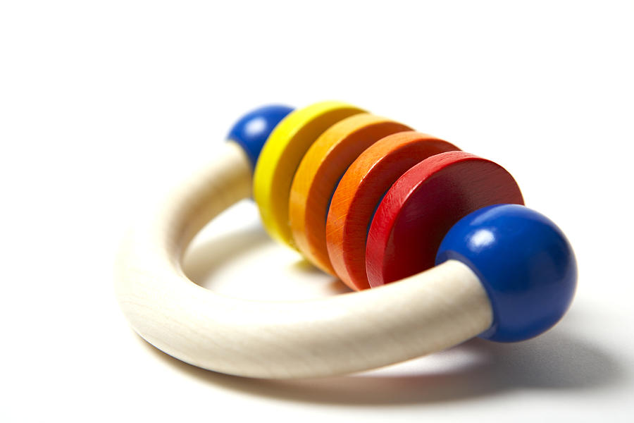 Wooden baby rattle, close-up Photograph by Noel Hendrickson