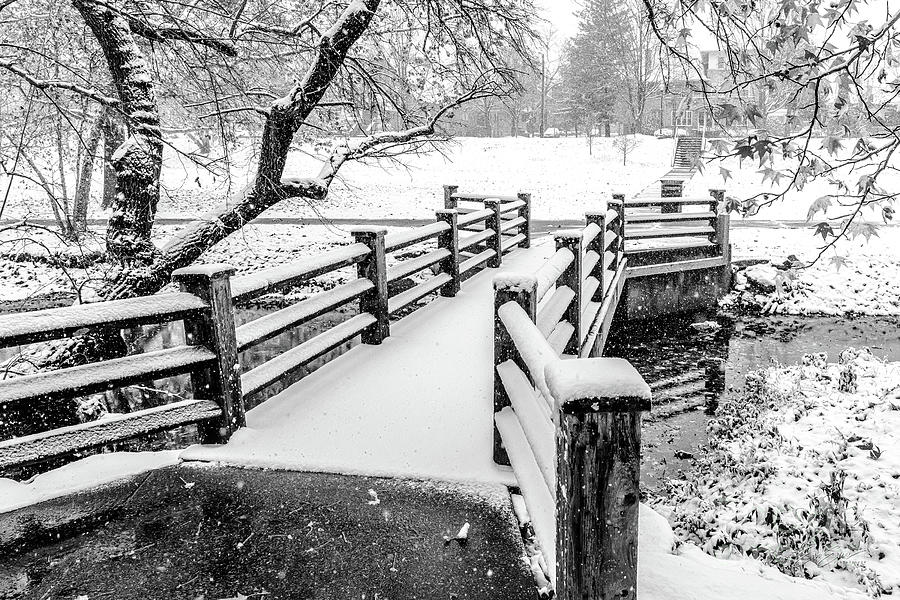 Wooden Bridge and Creek in snow storm Black and White Photograph by Aloha Art