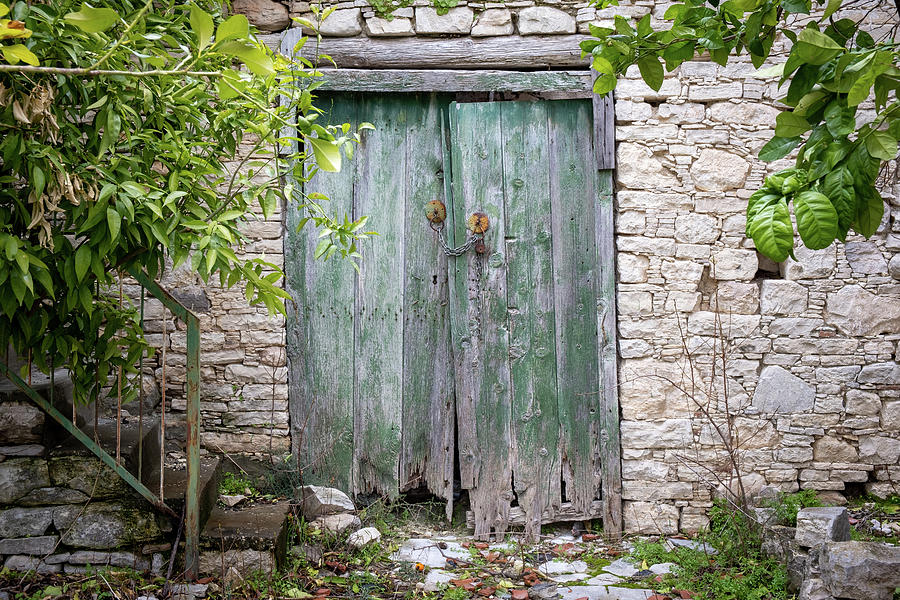 Wooden door on a stoned wall of a house Photograph by Michalakis Ppalis