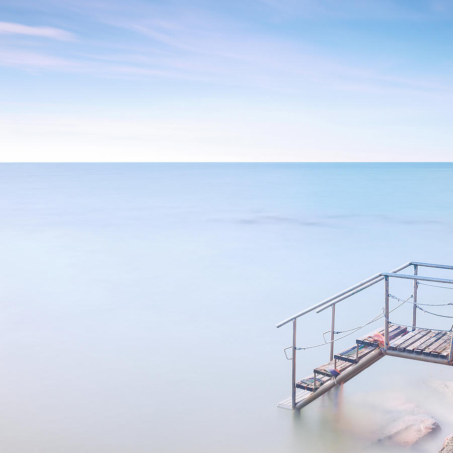 Wooden ladder pier to sea water. Long exposure. Photograph by Stefano Orazzini