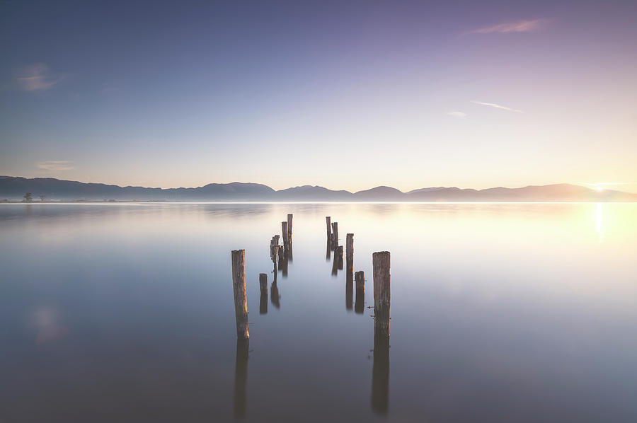 Wooden pier or jetty remains at sunrise. Massaciuccoli lake. Tor Photograph by Stefano Orazzini