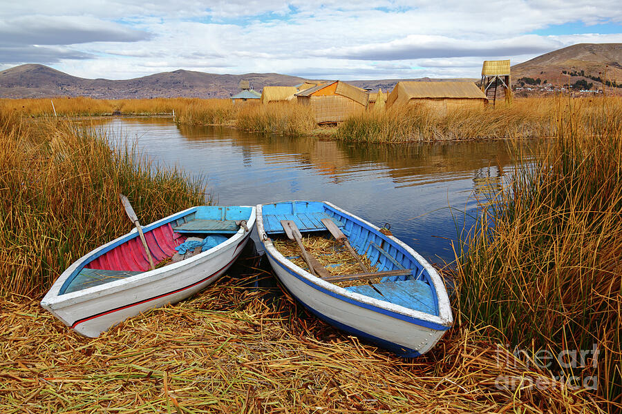 Boat Photograph - Wooden rowboats on the Uros Islands Lake Titicaca Peru by James Brunker